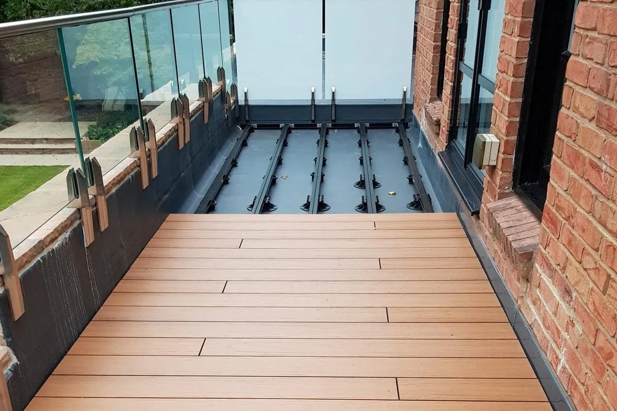 Balcony roof waterproofing beside a glass balustrade