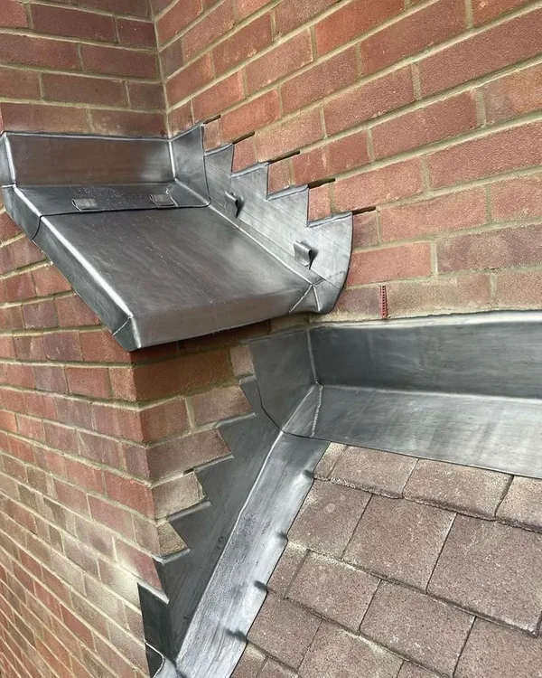 Lead flashing at a chimney and tiled roof junction