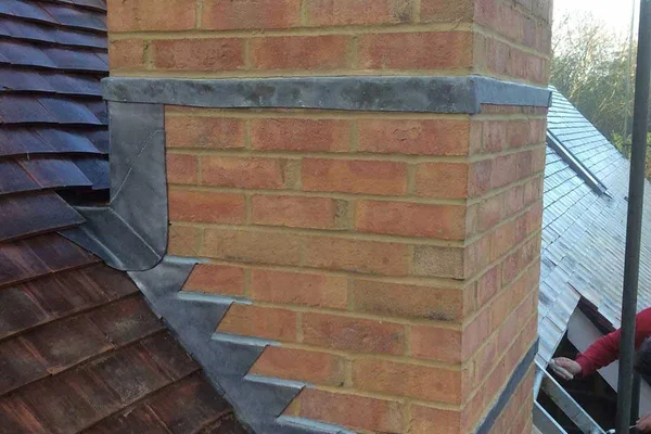 Lead flashing around a brick chimney and slate roof