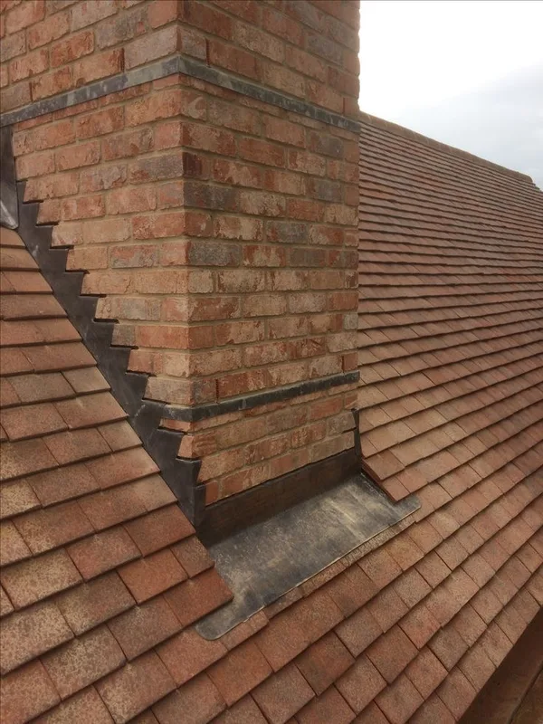 Lead flashing around a brick chimney