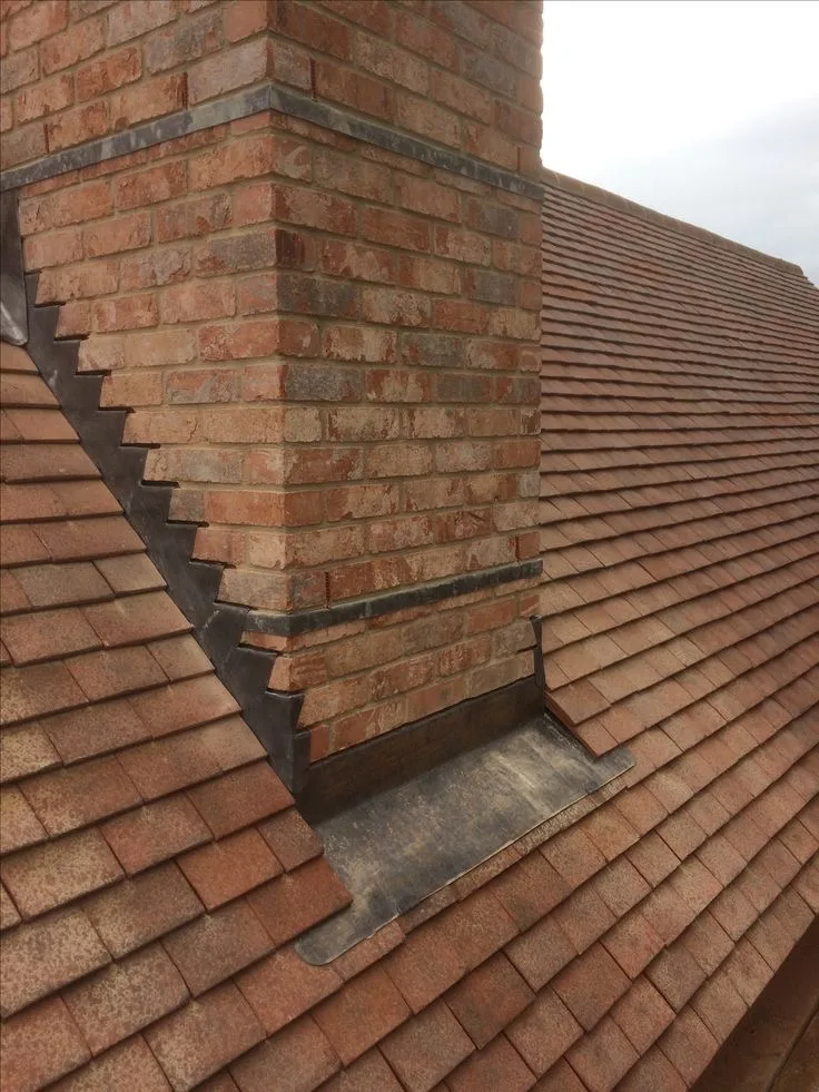 Lead flashing around a brick chimney