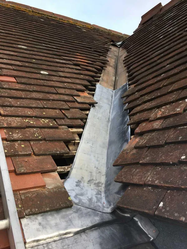 Lead-lined valley between tiled roof slopes