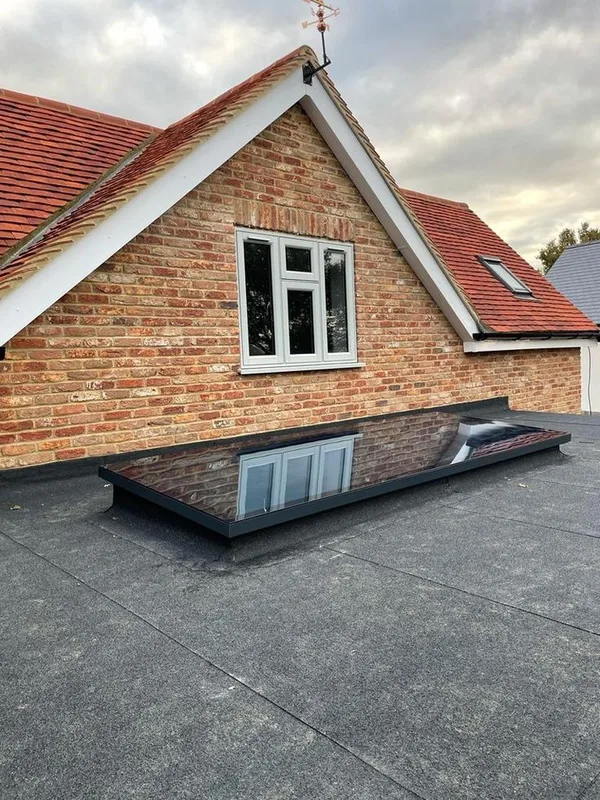 Pitched roof detail with a rooflight and flat roof junction