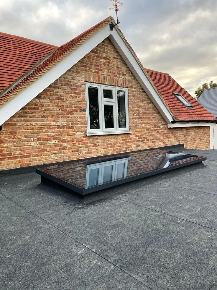 Pitched roof detail with a rooflight and flat roof junction