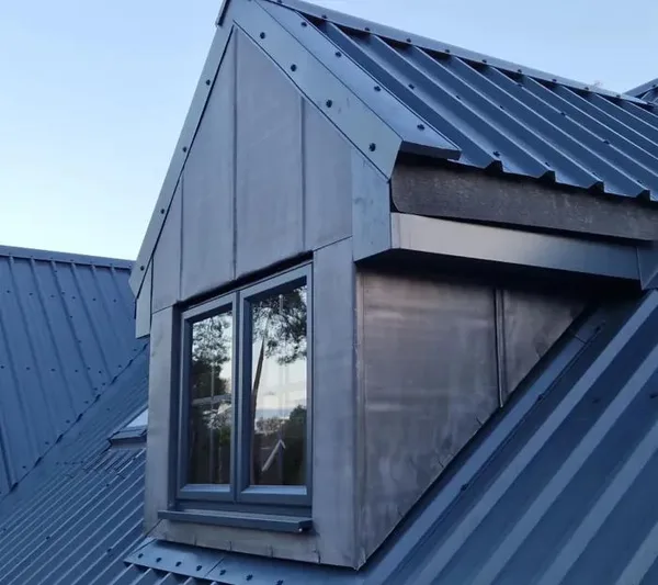 Blue-grey roof extension beside a dormer window