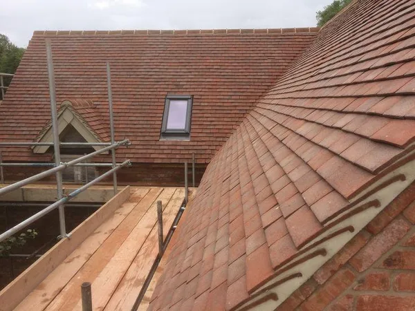 Tiled roof with a rooflight and scaffolding