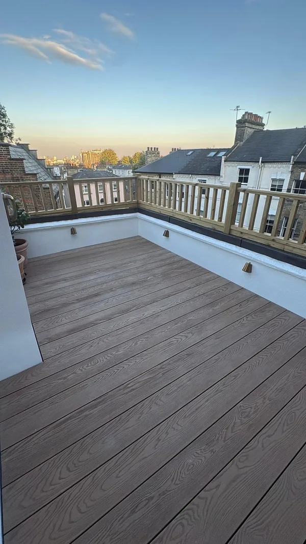 Roof terrace or balcony with timber decking and a glass balustrade