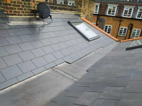 Slate roof with a rooflight and lead valley