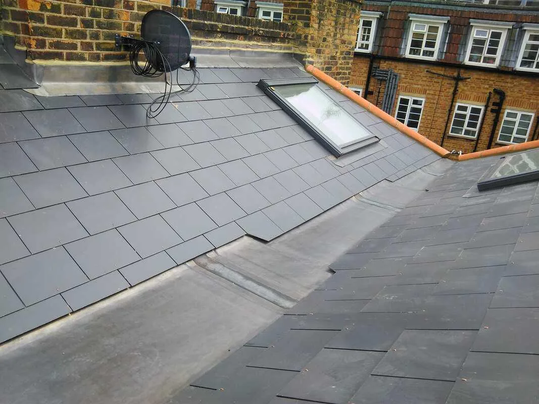 Slate roof with a rooflight and lead valley